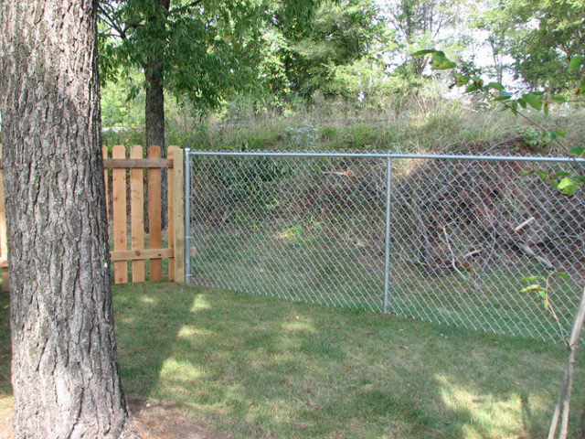 Residential chainlink and wood fence by Pickens Fence